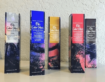 Four colorful boxed hair dye products from brite ethical color gloss, aligned in a row against a neutral background, each featuring different shades and vibrant designs.