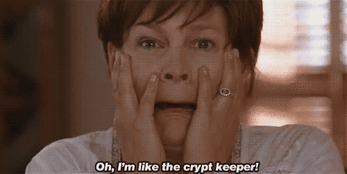 A woman with a short haircut looks shocked, holding her face in her hands, with the caption "oh, i'm like the crypt keeper!" displayed.