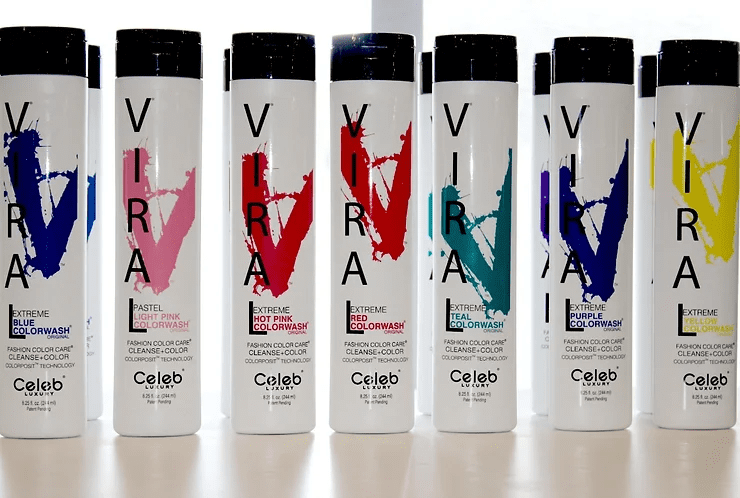 A row of hair color spray bottles with the brand name "viral" prominently displayed. each bottle features a different vibrant hair dye color represented by splashes on the packaging.