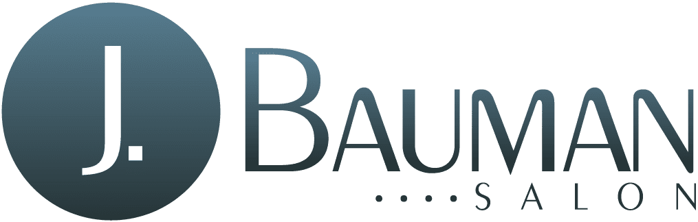 Logo of j. bauman salon featuring a dark blue circle with a white letter 'j' followed by the text "bauman salon" in gray capitals on a transparent background.